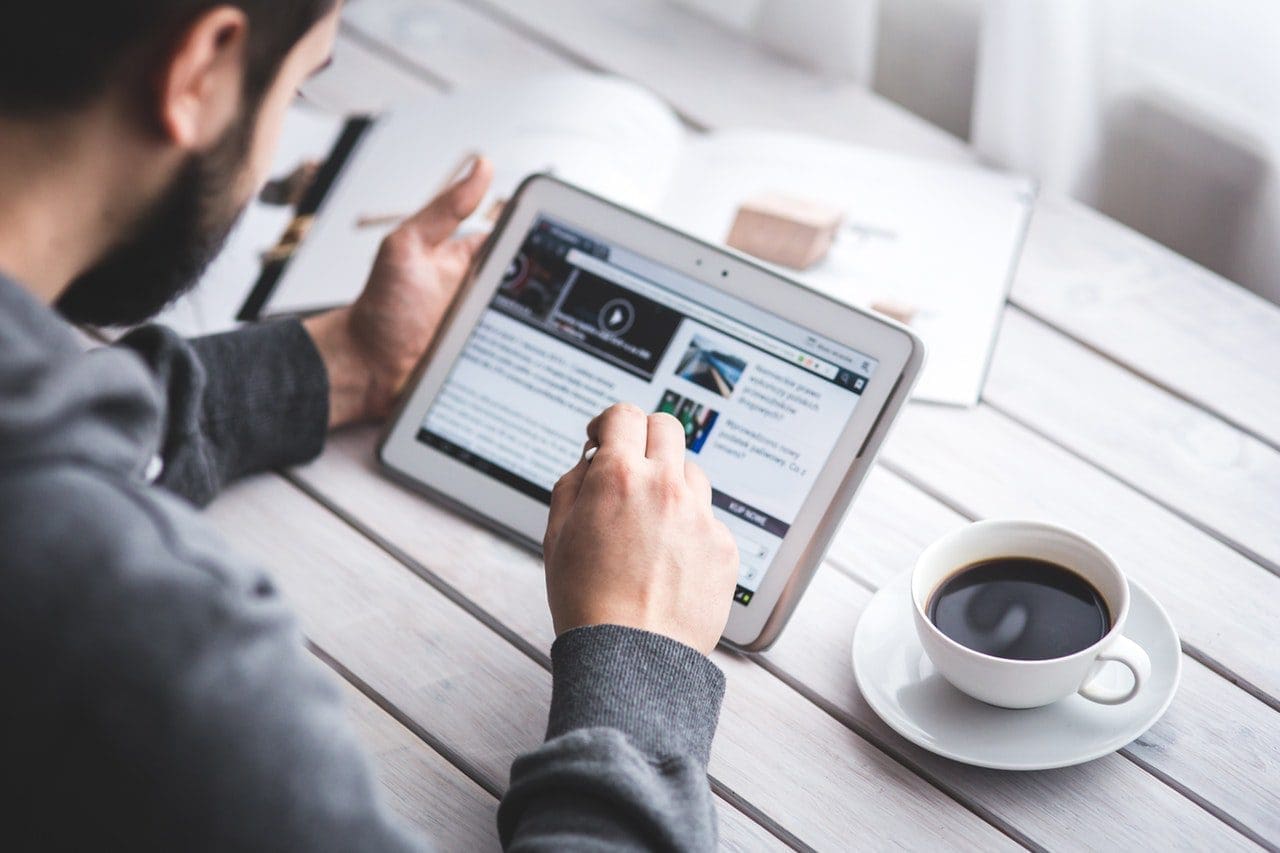 Man with news feed for press release post