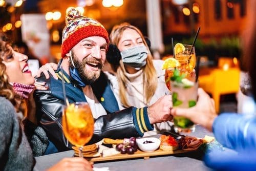 Friends cheersing at a bar for inauguration day post
