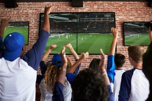 Friends watching TV photo for sports bar post